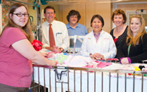 From left: Jennifer Davies (mom to 5-month-old Elizabeth, a PICU patient, in crib); Tom Brazelton, MD, MPH; AFCH Quality Analyst Lisa Buel, RN, BSN, MPH, CPHQ; infection control practitioner Rosa Mak, MS, RD, MS-PH; clinical nurse manager Anne Moseley, RN, BSN; and nurse Roxana Peters, RN, BSN
